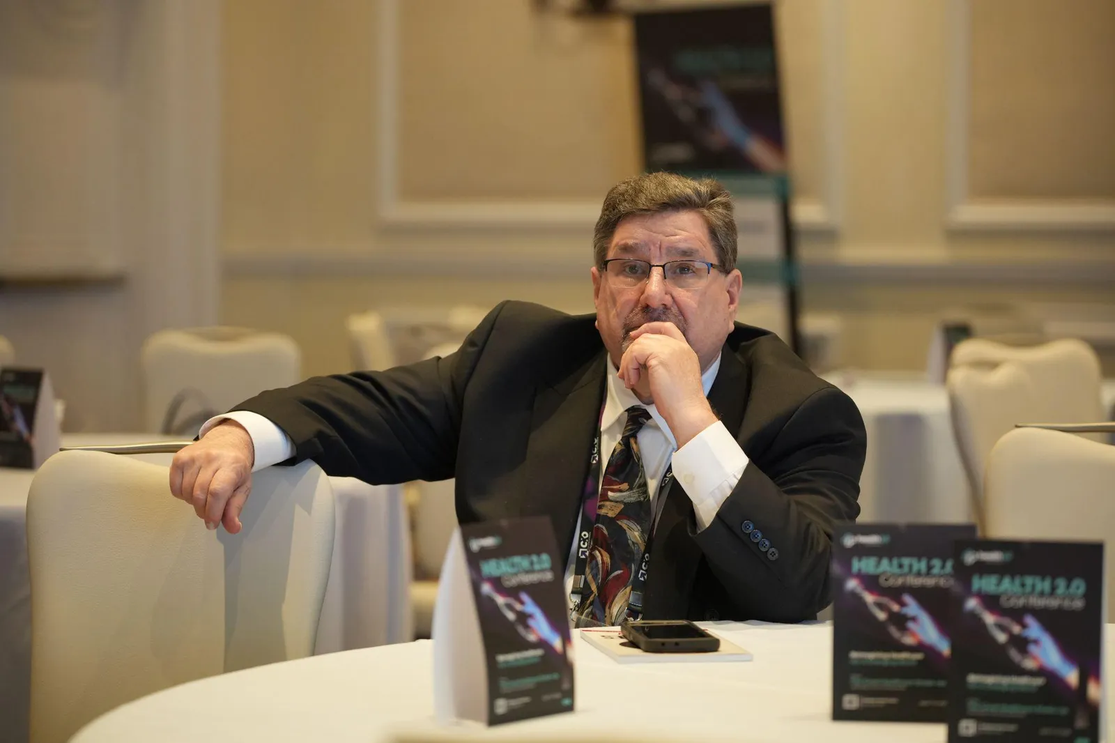 David A. Ward Sr. sits thoughtfully at a round table in a conference setting
